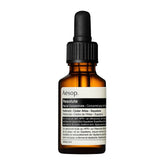 Aesop Resolute facial concentrate in an amber glass dropper bottle with a black cap and white label, shown on a plain white background.