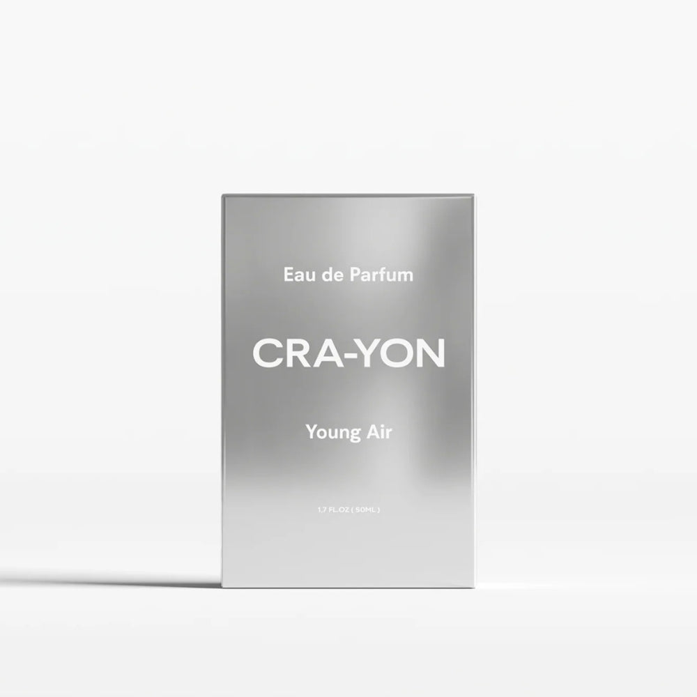 A rectangular silver perfume box standing upright on a white background. The box has a brushed metallic finish with white text reading 'Eau de Parfum', 'CRA-YON', and 'Young Air'.