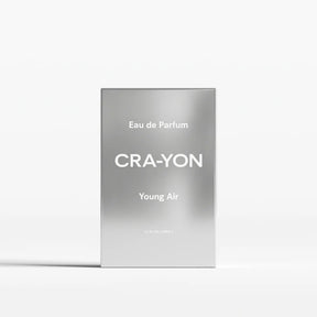 A rectangular silver perfume box standing upright on a white background. The box has a brushed metallic finish with white text reading 'Eau de Parfum', 'CRA-YON', and 'Young Air'.