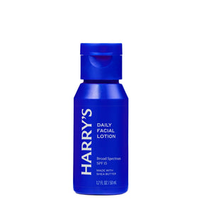 A blue bottle of Harry's Daily Facial Lotion SPF 15, featuring a matching blue flip-top cap, set against a plain white background.