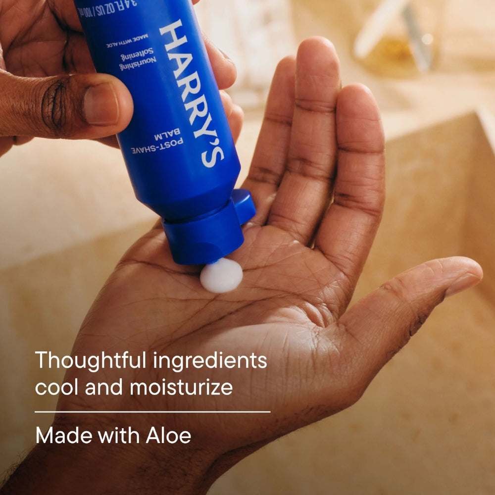 A person squeezes blue Harry's Post-Shave Balm onto the back of their hand, with text overlay reading 'Thoughtful ingredients cool and moisturize Made with Aloe'.