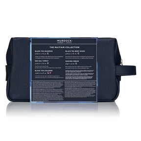 A dark navy blue Murdock London travel toiletry bag with a clear front label displaying product details from 'The Mayfair Collection'.