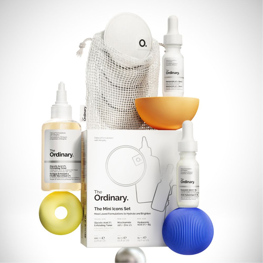 The Ordinary skincare product set with bottles, a box, and accessories on a white background